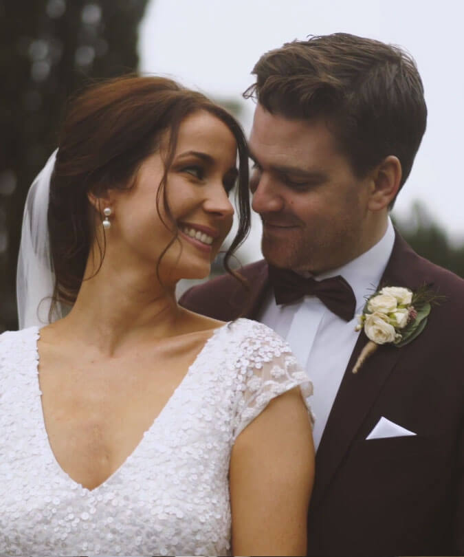Groom embracing bride