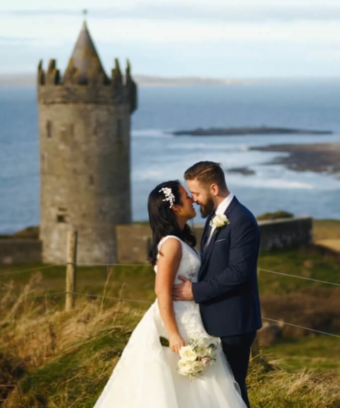 Wedding couple embracing on coast
