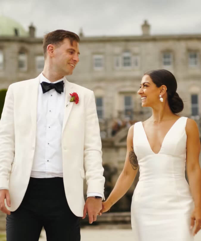 Wedding couple holding hands at estate